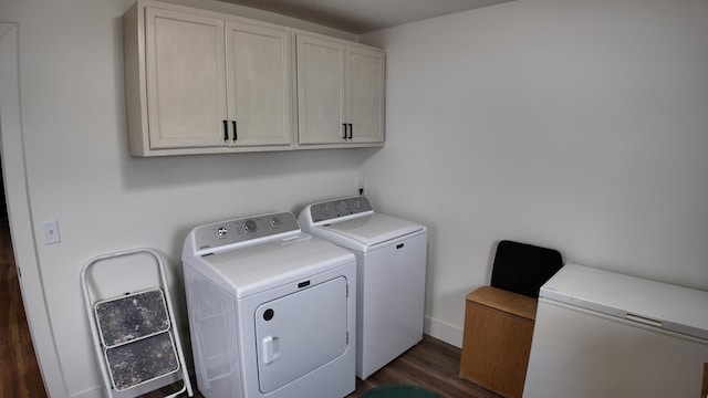 laundry room featuring dark hardwood / wood-style flooring, cabinets, and independent washer and dryer