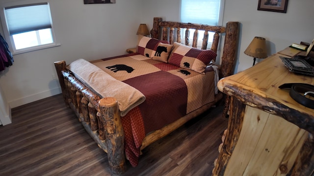 bedroom with dark hardwood / wood-style flooring