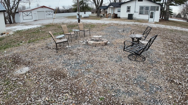 view of yard with central AC and a fire pit