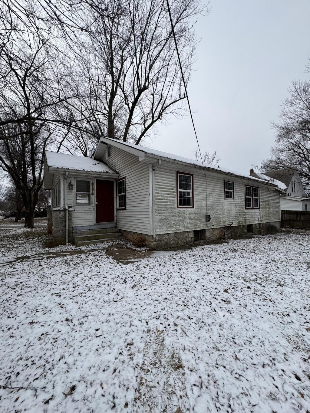 view of snow covered rear of property