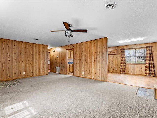 spare room with ceiling fan and light colored carpet