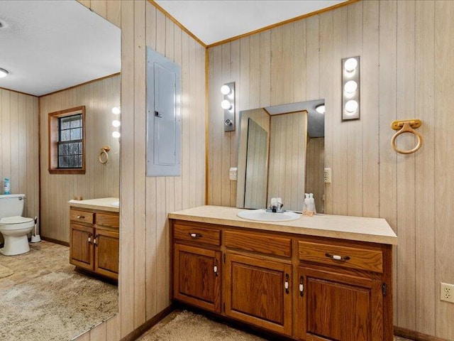 bathroom with electric panel, wooden walls, crown molding, and toilet