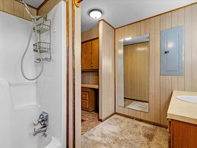 bathroom with wooden walls, vanity, electric panel, and bathing tub / shower combination