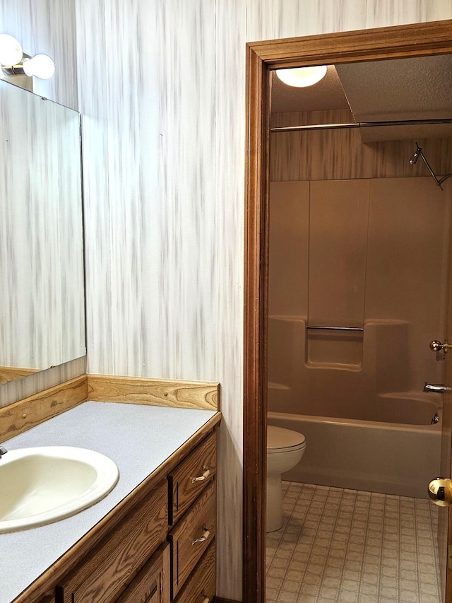 full bathroom featuring vanity,  shower combination, and toilet