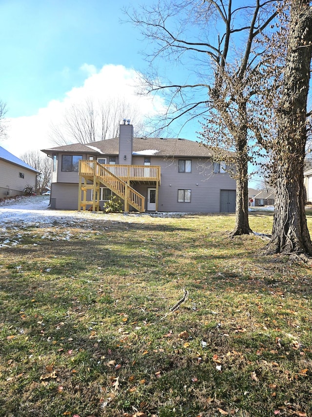 back of property featuring a lawn and a deck