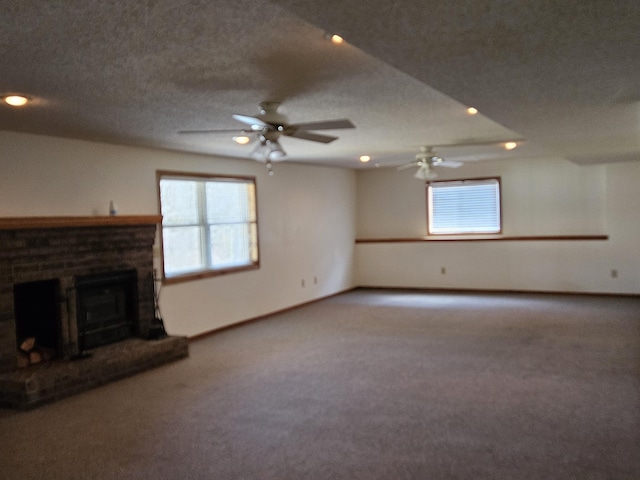 unfurnished living room with carpet flooring, ceiling fan, and a textured ceiling