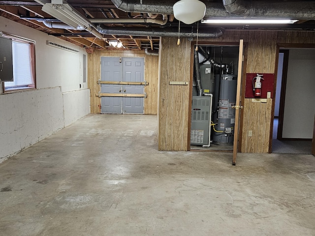 basement with gas water heater and wood walls