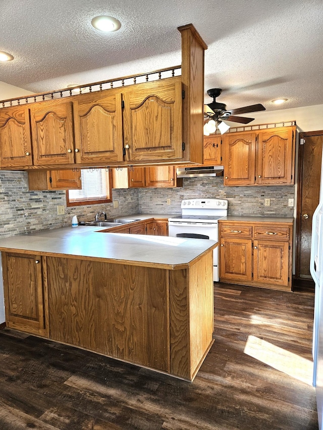 kitchen featuring white range with electric cooktop, kitchen peninsula, a textured ceiling, and dark wood-type flooring