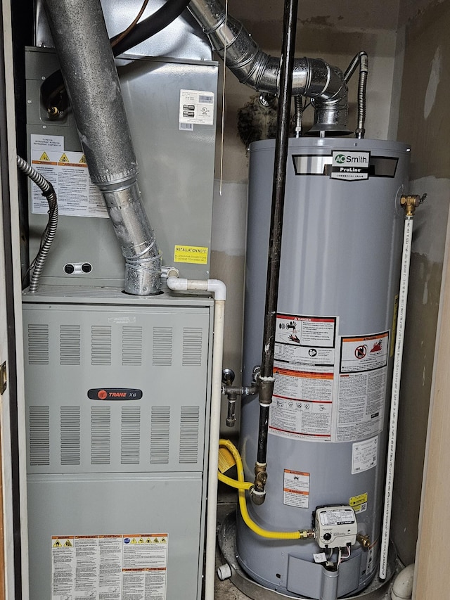 utilities featuring heating unit and gas water heater