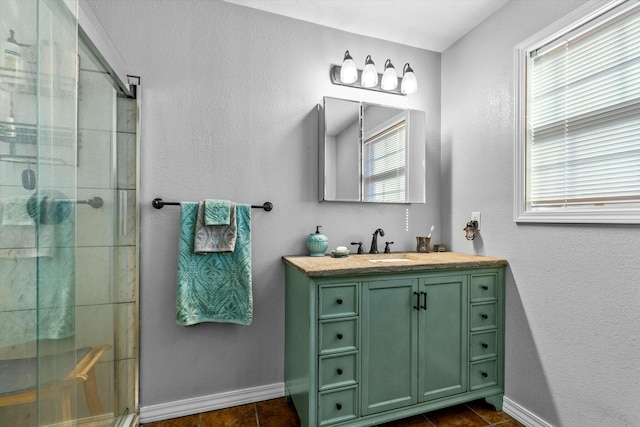 bathroom with a wealth of natural light, walk in shower, and vanity