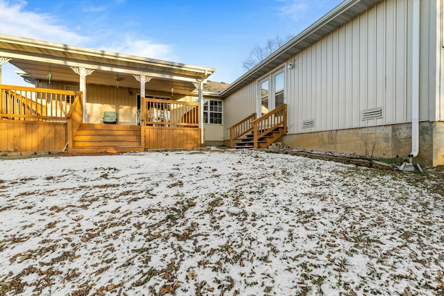 view of snow covered rear of property