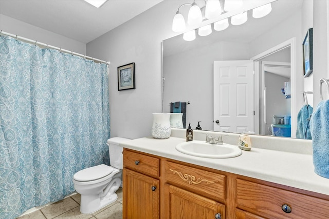 bathroom with toilet, tile patterned floors, and vanity