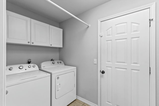 washroom with washer and dryer, cabinets, and light tile patterned floors