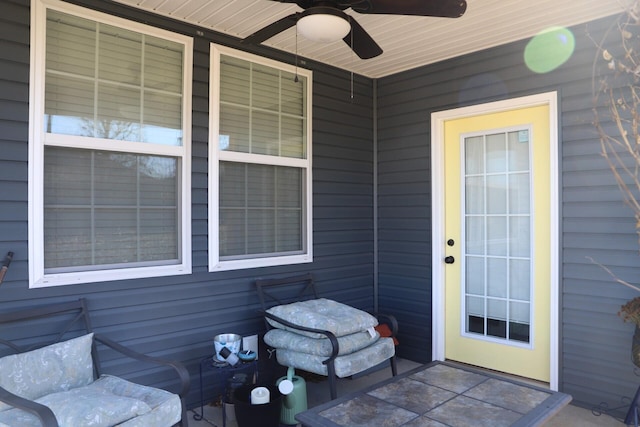 view of exterior entry featuring ceiling fan