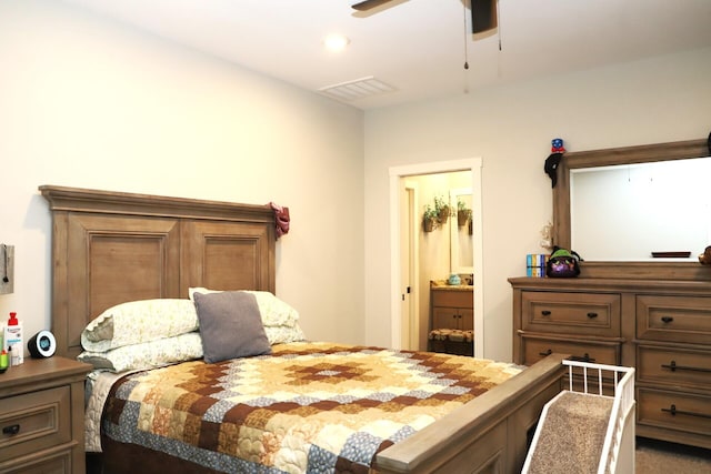 bedroom featuring ensuite bath, ceiling fan, and carpet