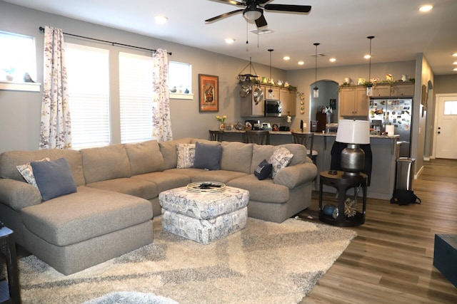 living room with dark hardwood / wood-style floors and ceiling fan