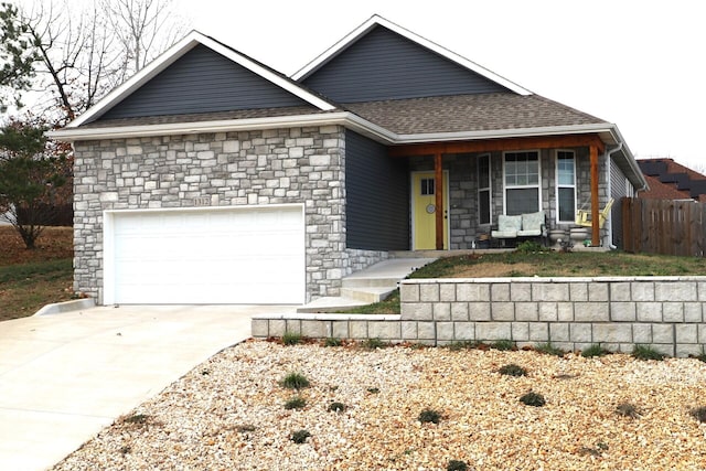 ranch-style house with a porch and a garage