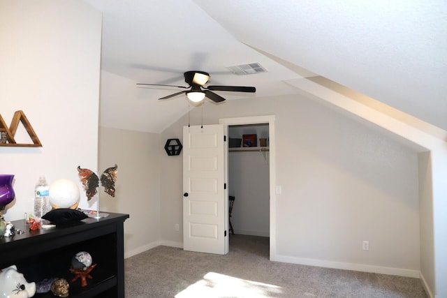 carpeted bedroom with a closet, ceiling fan, and lofted ceiling