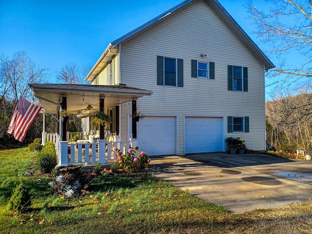 back of property with a garage and a porch