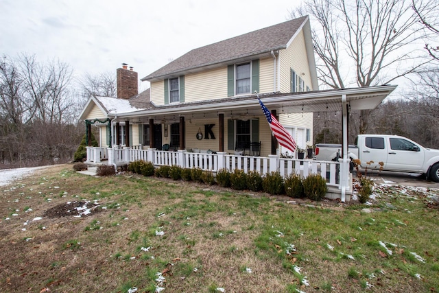 view of front of home featuring a front lawn and covered porch