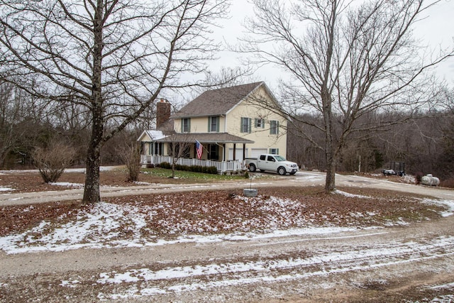 view of front of property with a garage and covered porch