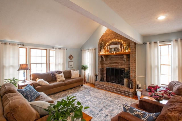 living room with lofted ceiling, a fireplace, hardwood / wood-style floors, and a textured ceiling