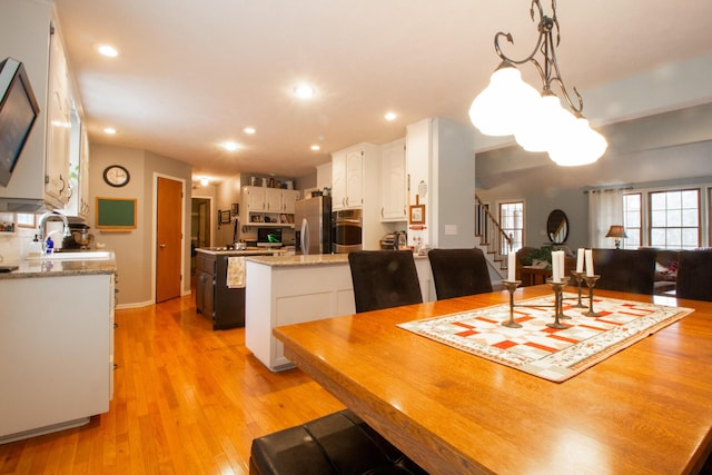 dining room with light hardwood / wood-style floors and sink