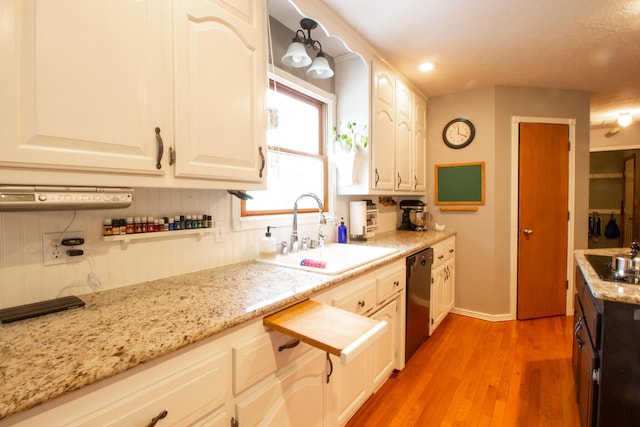 kitchen with white cabinetry, sink, and black appliances