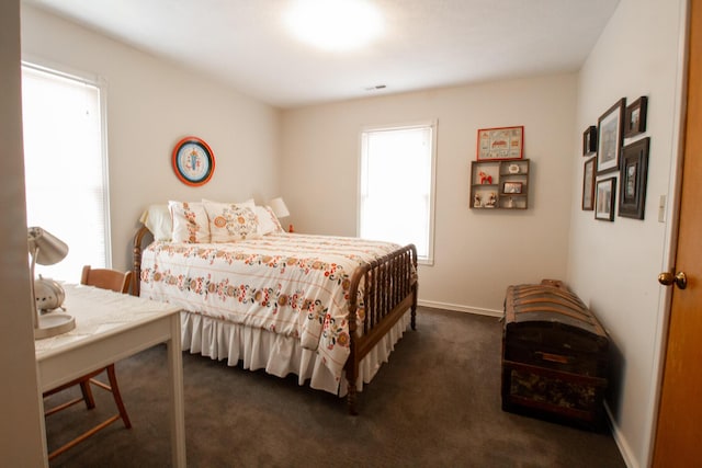 carpeted bedroom with multiple windows