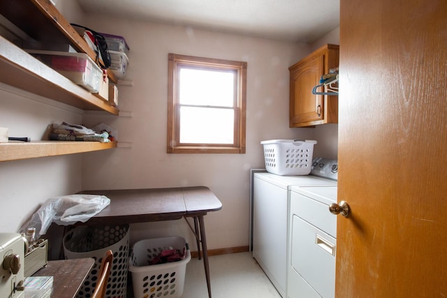 laundry room with cabinets and washer and dryer