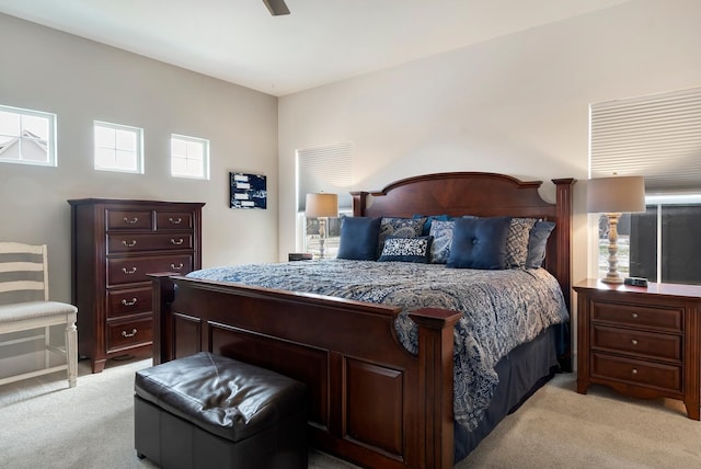 bedroom featuring light colored carpet and ceiling fan