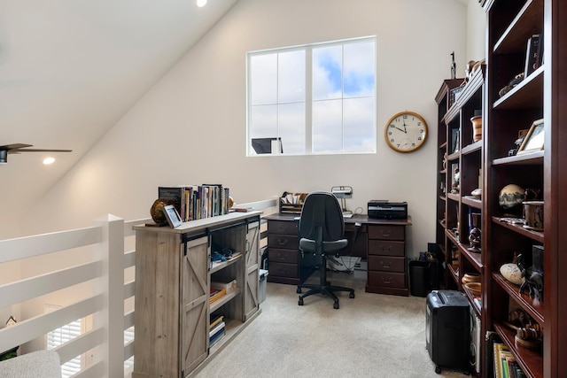 carpeted office space with vaulted ceiling