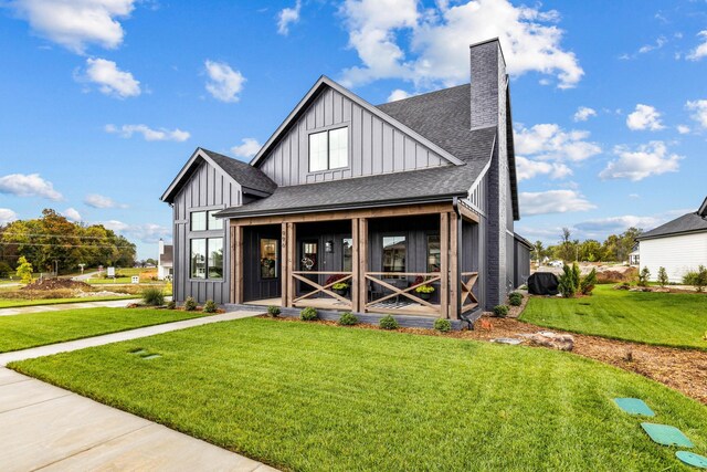 view of front facade featuring a front lawn and a sunroom