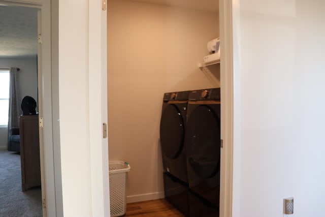 laundry area with carpet floors and washing machine and clothes dryer