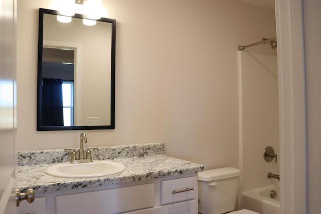 full bathroom featuring toilet, vanity, and bathing tub / shower combination