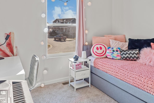 carpeted bedroom with multiple windows