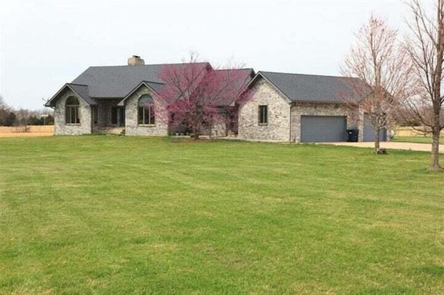 french country inspired facade with a garage and a front lawn