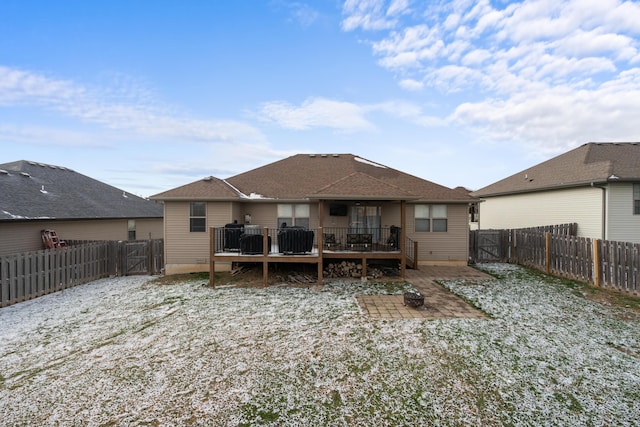 back of house featuring a wooden deck