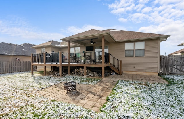 back of house featuring ceiling fan, an outdoor fire pit, and a wooden deck