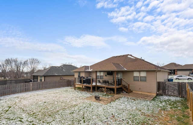 rear view of property featuring a wooden deck