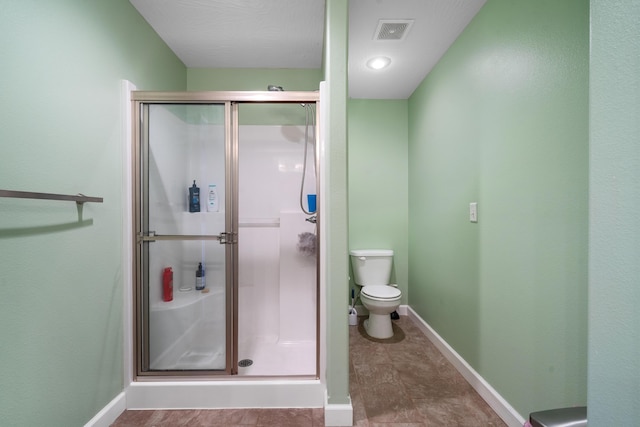 bathroom with toilet and walk in shower