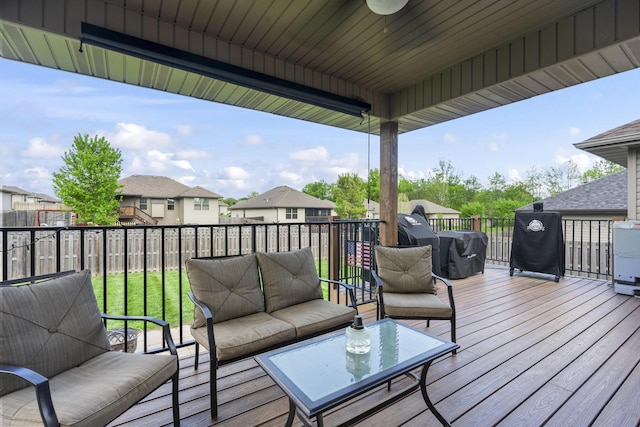 wooden terrace with a residential view, an outdoor hangout area, and fence