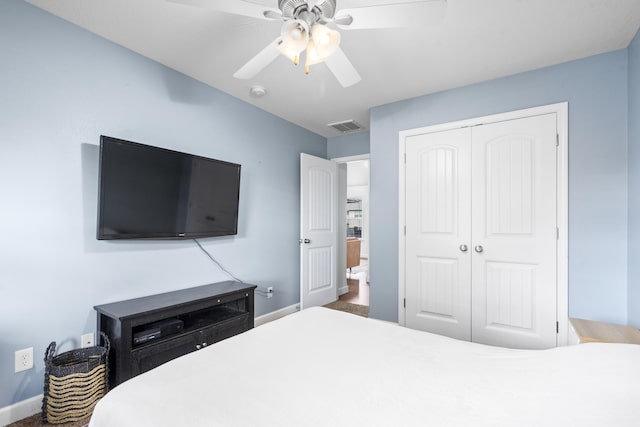bedroom with a closet, visible vents, a ceiling fan, and baseboards