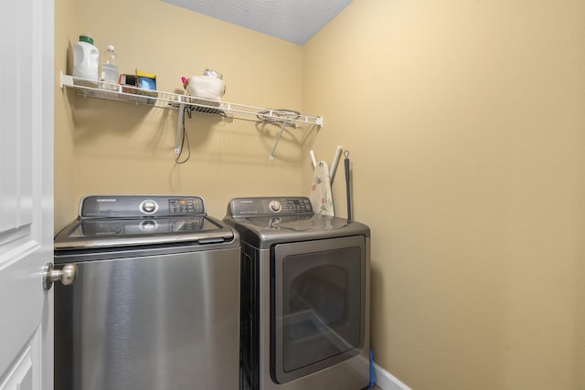 washroom with washer and clothes dryer and laundry area
