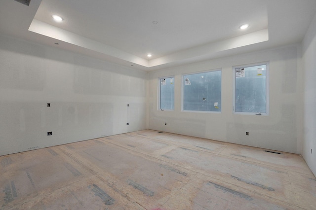 empty room featuring a tray ceiling