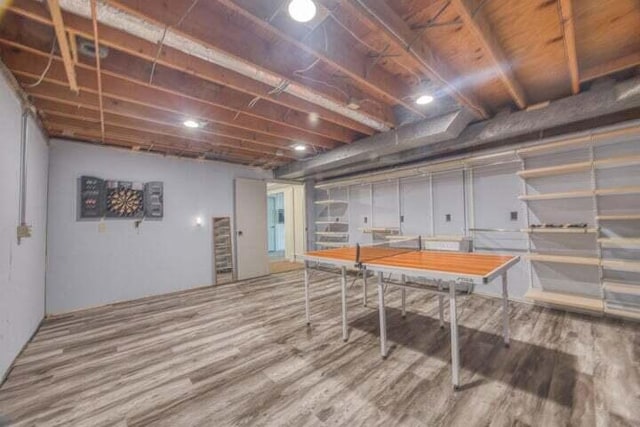 basement with hardwood / wood-style flooring