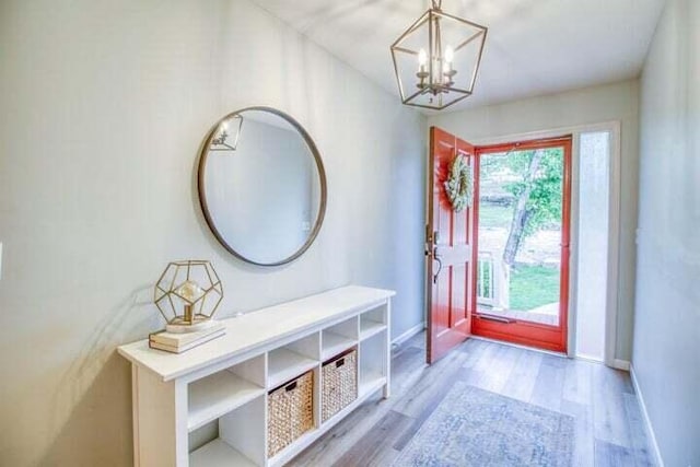 entryway with a notable chandelier and light hardwood / wood-style flooring