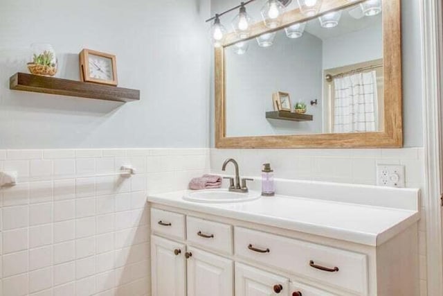 bathroom with vanity and tile walls