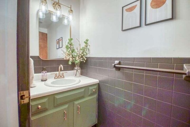 bathroom featuring vanity and tile walls