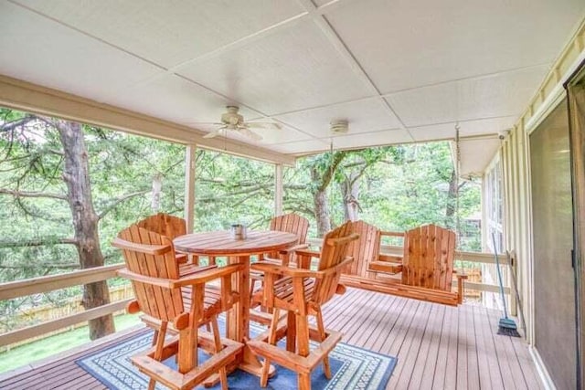 sunroom featuring ceiling fan and a healthy amount of sunlight